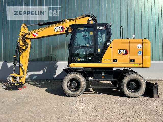 Cat M314-07A - Gumikerekes kotró: 2 kép. Cat M314-07A - Gumikerekes kotró: 2 kép.
