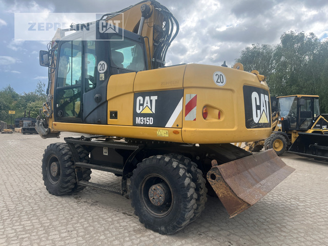 Cat M315D - Gumikerekes kotró: 1 kép. Cat M315D - Gumikerekes kotró: 1 kép.