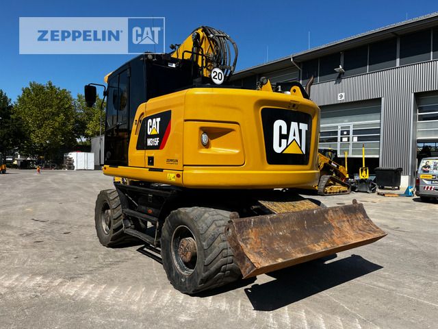 Cat M315F - Gumikerekes kotró: 2 kép. Cat M315F - Gumikerekes kotró: 2 kép.