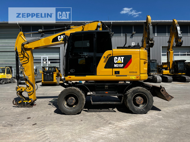 Cat M315F - Gumikerekes kotró: 1 kép. Cat M315F - Gumikerekes kotró: 1 kép.