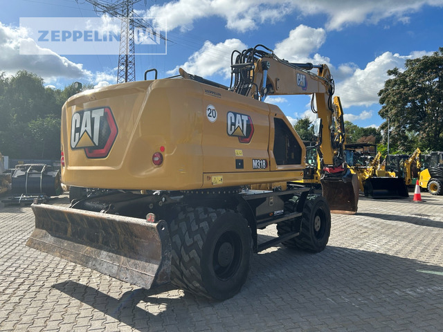 Cat M318-07A - Gumikerekes kotró: 5 kép. Cat M318-07A - Gumikerekes kotró: 5 kép.