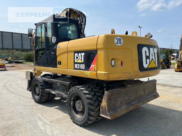 Cat M318D - Gumikerekes kotró: 4 kép. Cat M318D - Gumikerekes kotró: 4 kép.