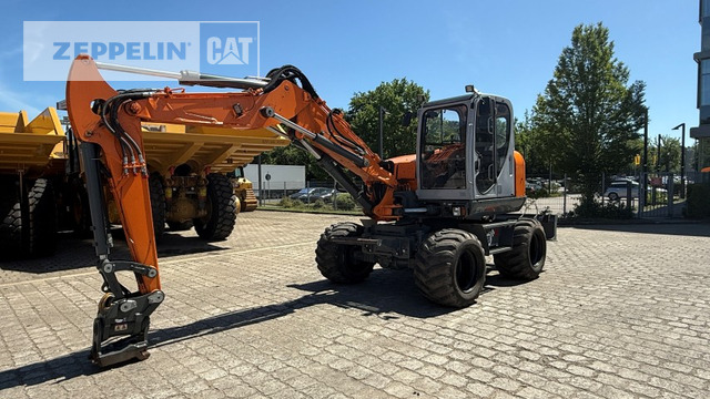 Wacker EW100 - Gumikerekes kotró: 2 kép. Wacker EW100 - Gumikerekes kotró: 2 kép.